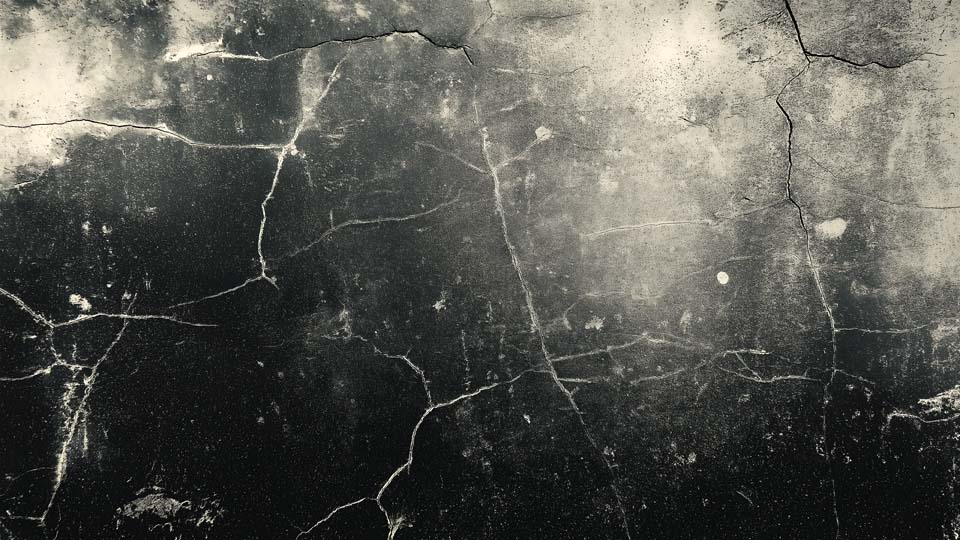 Dirty, scratched, and worn black metal surface