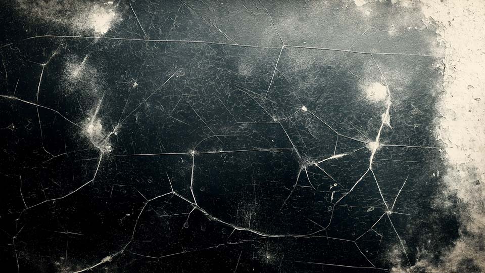 Dirty, scratched, and worn black metal surface