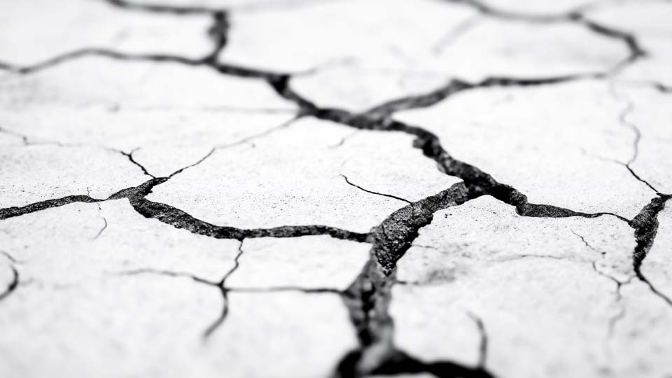 Black and white close-up of cracked concrete