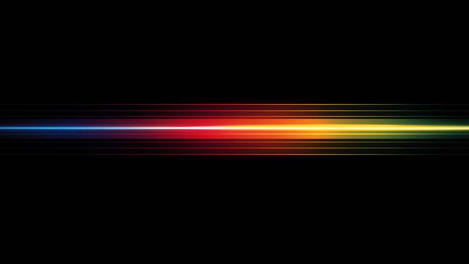 Horizontal rainbow-colored light streak on a black background