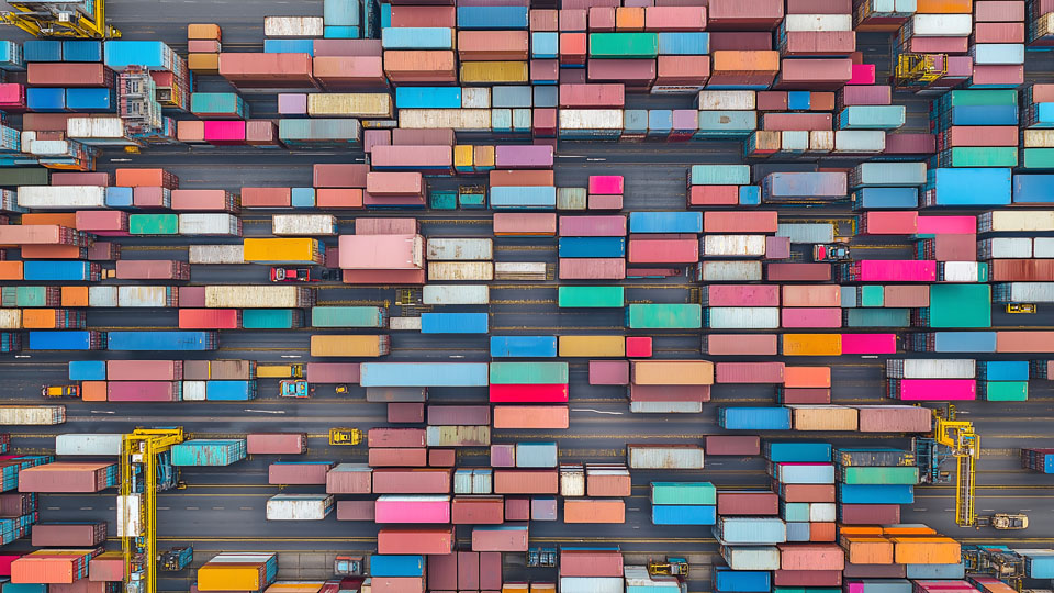 Aerial view of cargo containers stacked in an industrial port