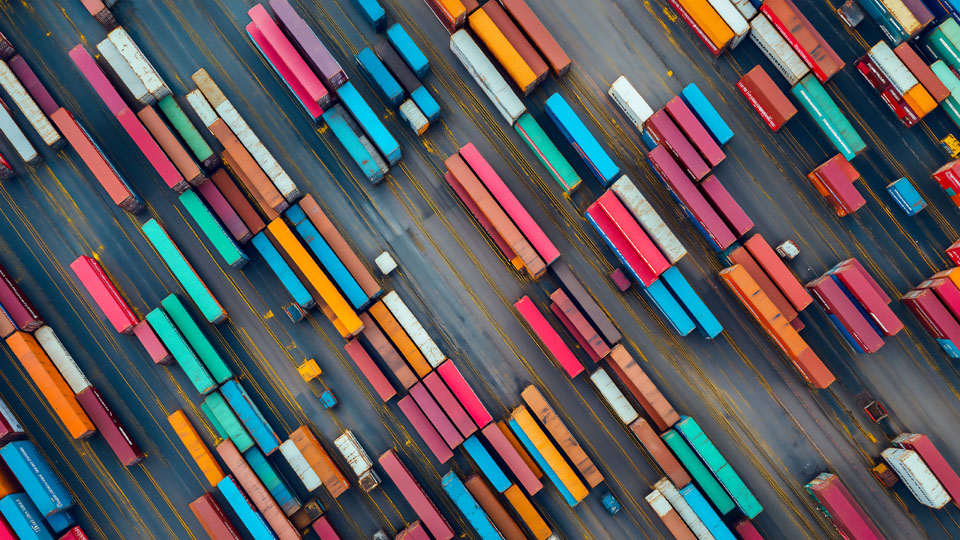 Aerial view of cargo containers stacked in an industrial port