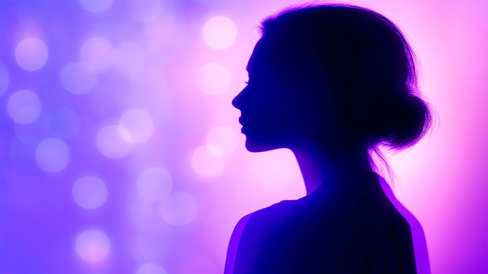 Silhouette of a young woman with purple lights