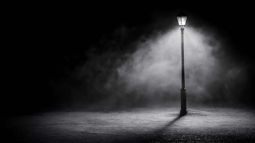 Isolated street lamp casting eerie shadows