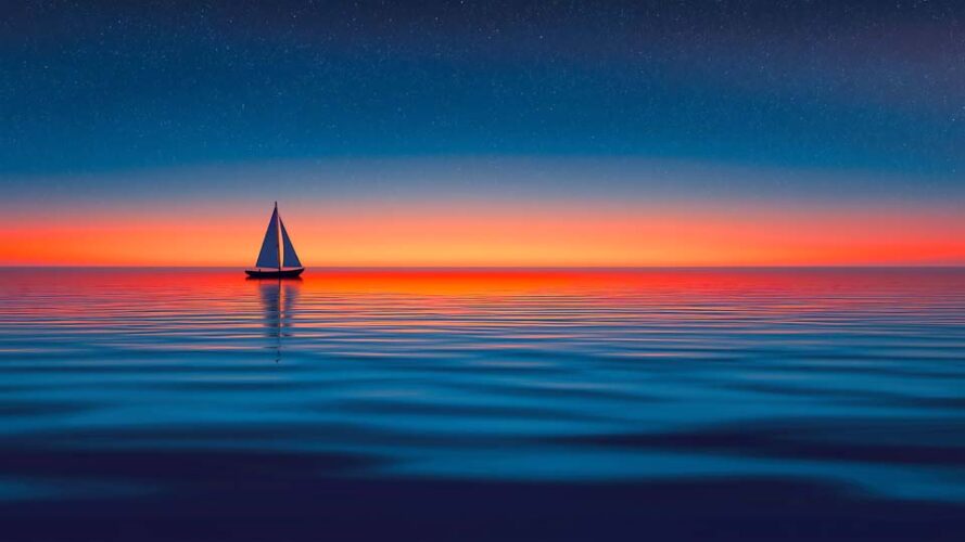 Sailing boat on a calm sea at sunset