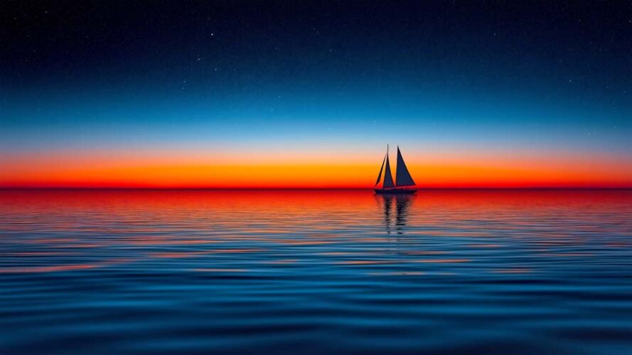 Sailing boat on a calm sea at sunset