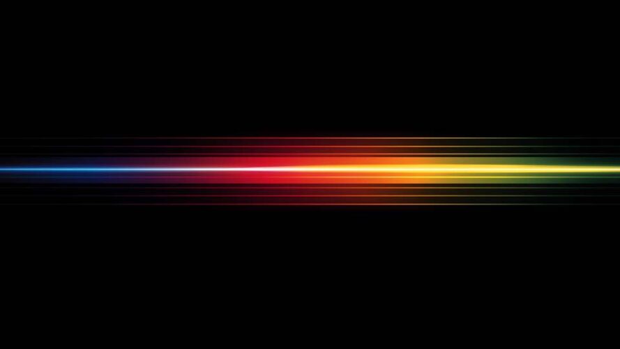 Horizontal rainbow-colored light streak on a black background