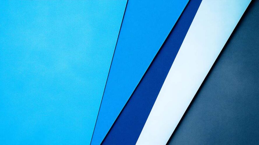 Minimalist blue background with diagonal stripes of paper