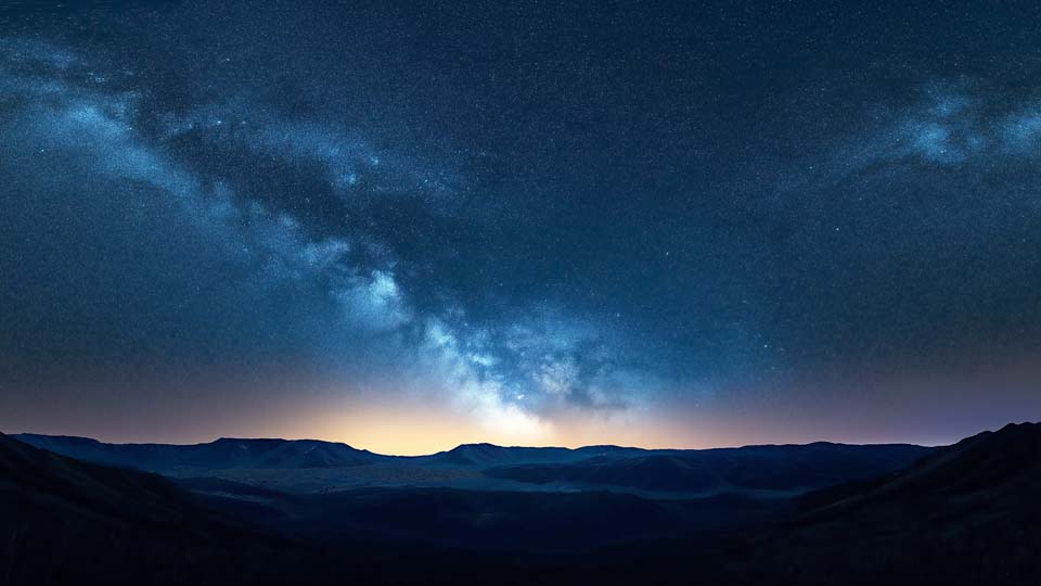 Starry sky over the mountains at night
