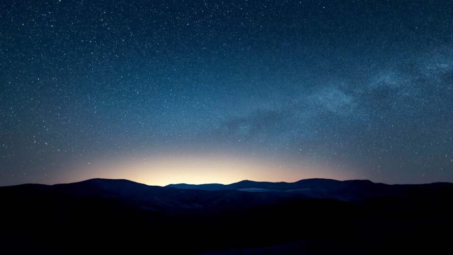 Starry sky over the mountains at night
