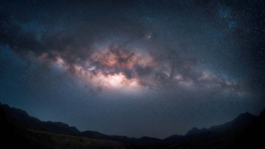 Starry sky over the mountains at night