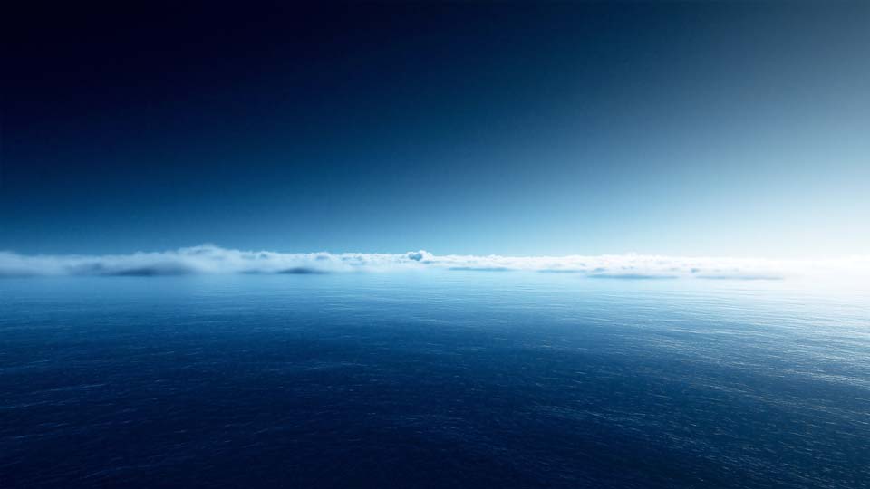 Deep blue sea with light fog on the horizon