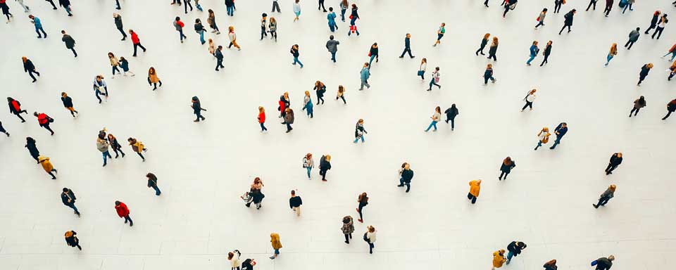 Crowd walking on a white floor