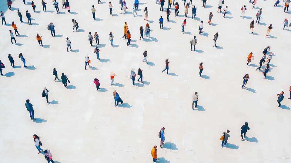 Crowd walking on a white floor