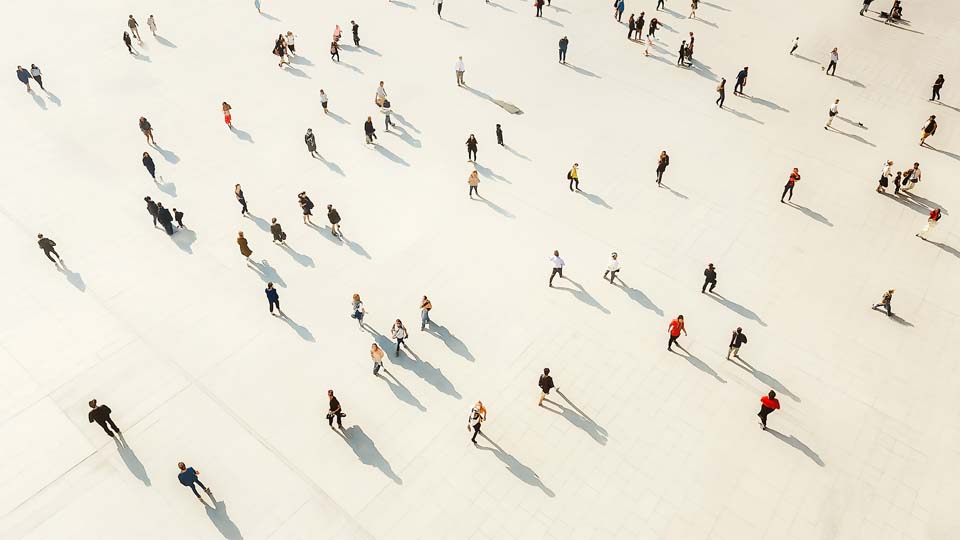 Crowd walking on a white floor