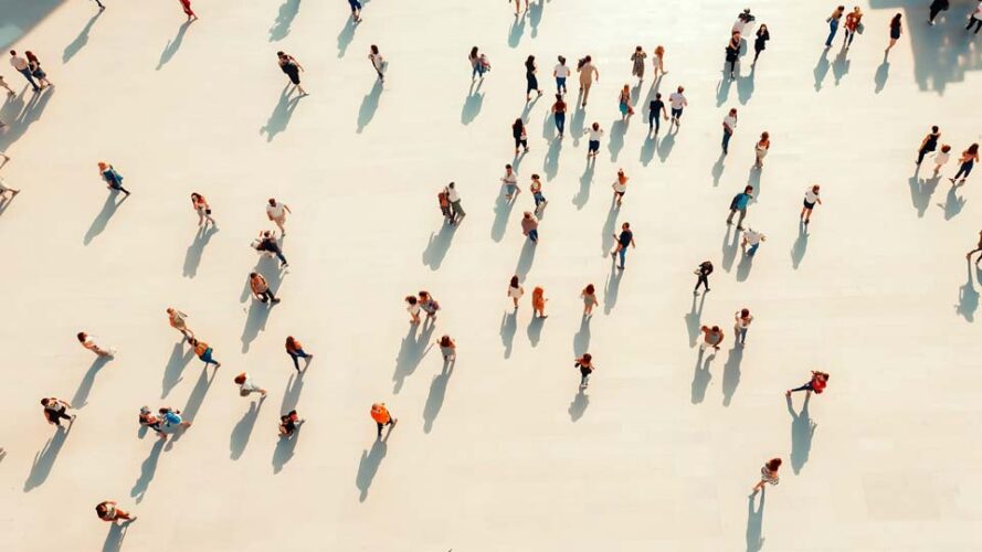 Crowd walking on a white floor