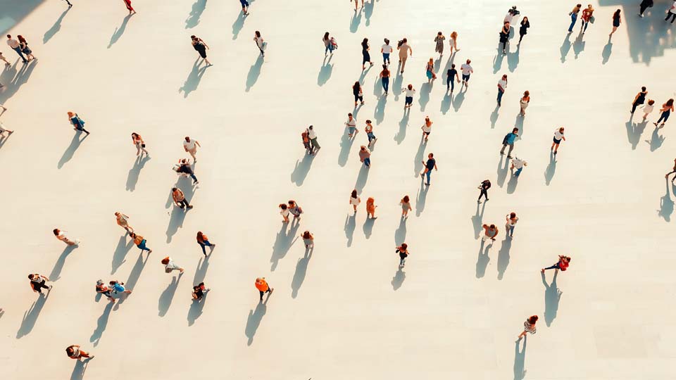 Crowd walking on a white floor
