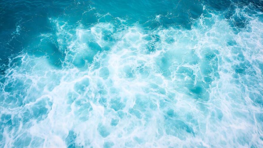 Blue sea water with white foam