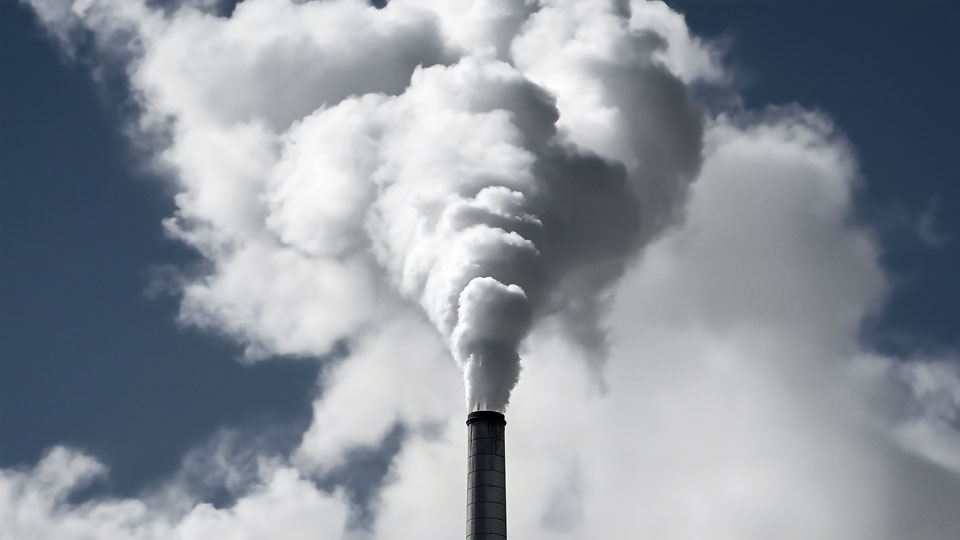 Smoke billowing from a factory chimney