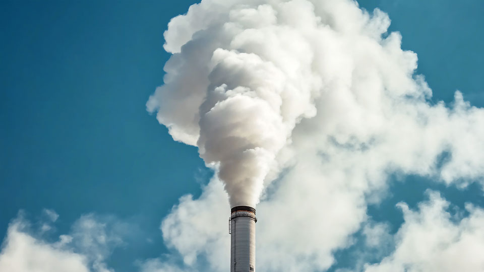 Smoke billowing from a factory chimney
