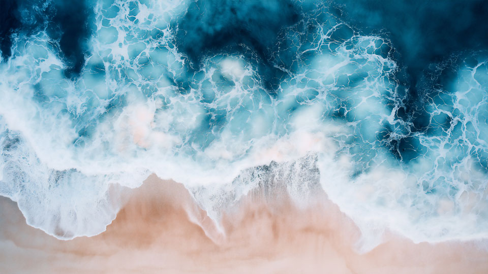Ocean waves against a sandy beach