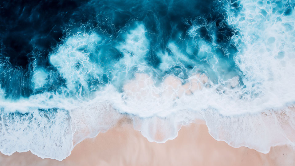 Ocean waves against a sandy beach