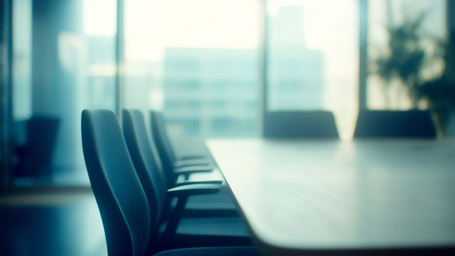 Empty boardroom table with chairs