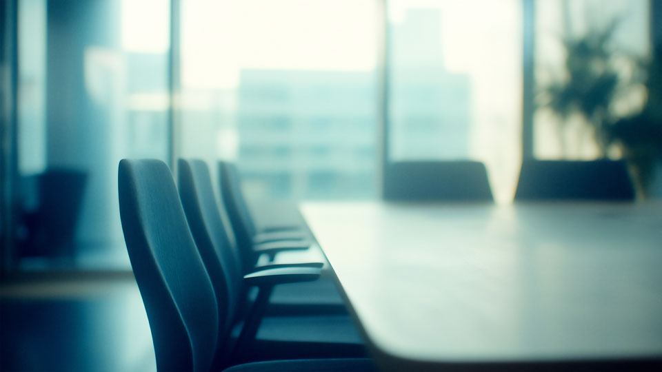 Empty boardroom table with chairs