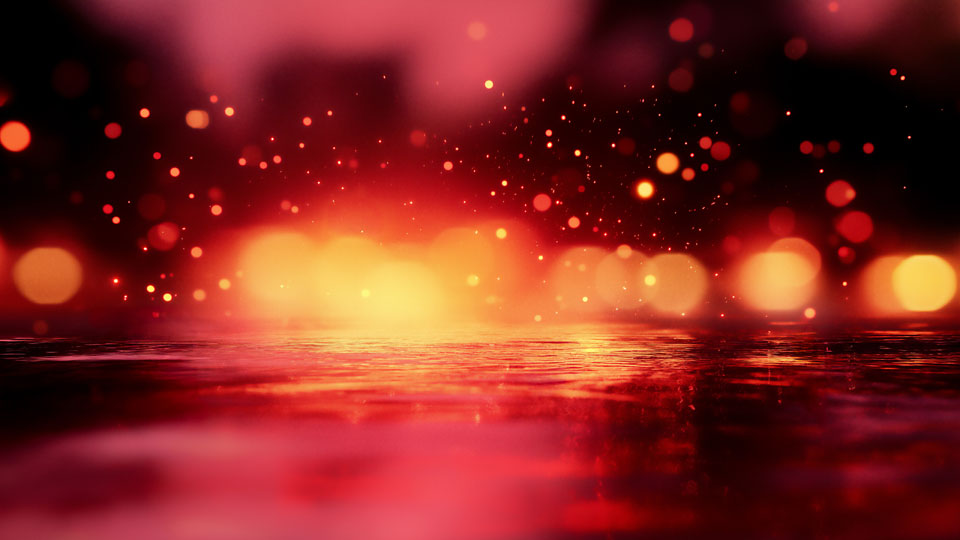 Pink and red reflections on a street in the rain