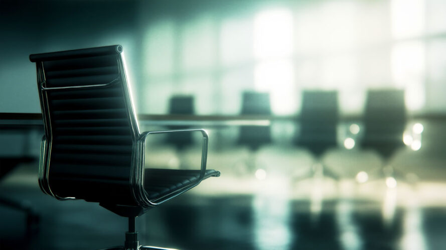 Black office chair in front of a conference table