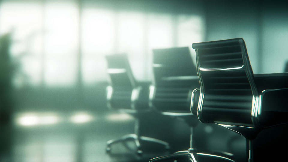 Black office chair in front of a conference table