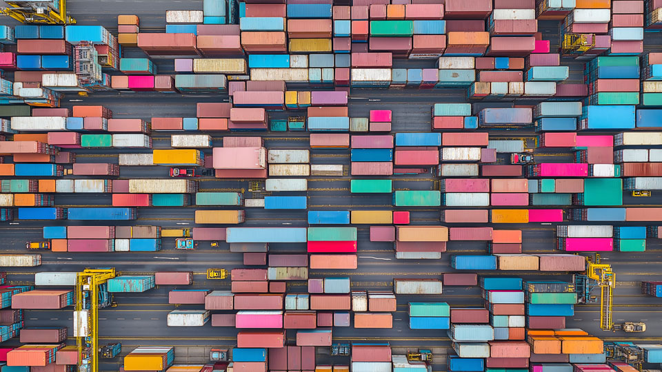 Aerial view of cargo containers stacked in an industrial port