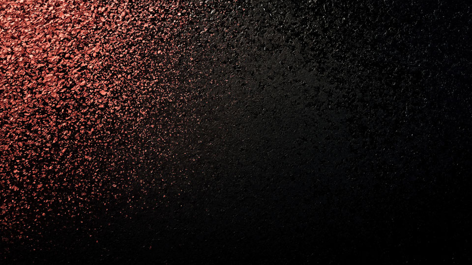 Black background with rose gold powder particles