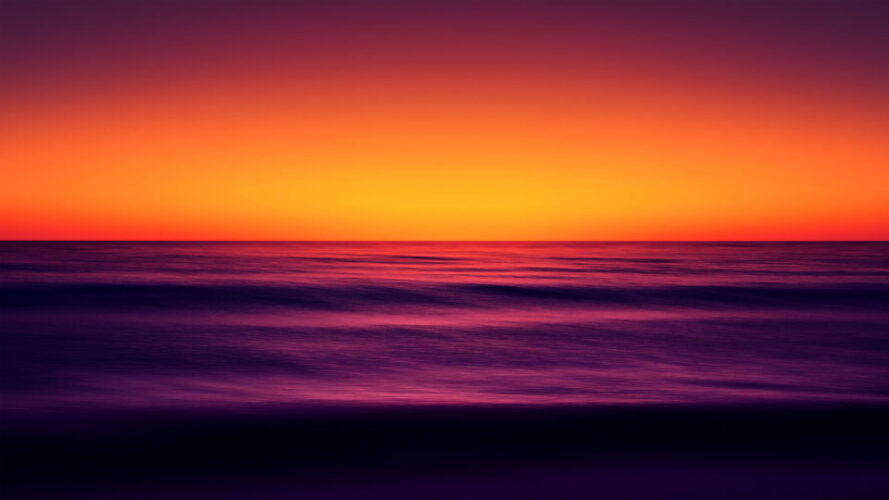 Orange and purple ocean horizon at sunset