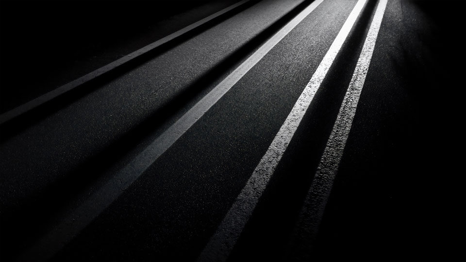 Close-up of asphalt with white stripes