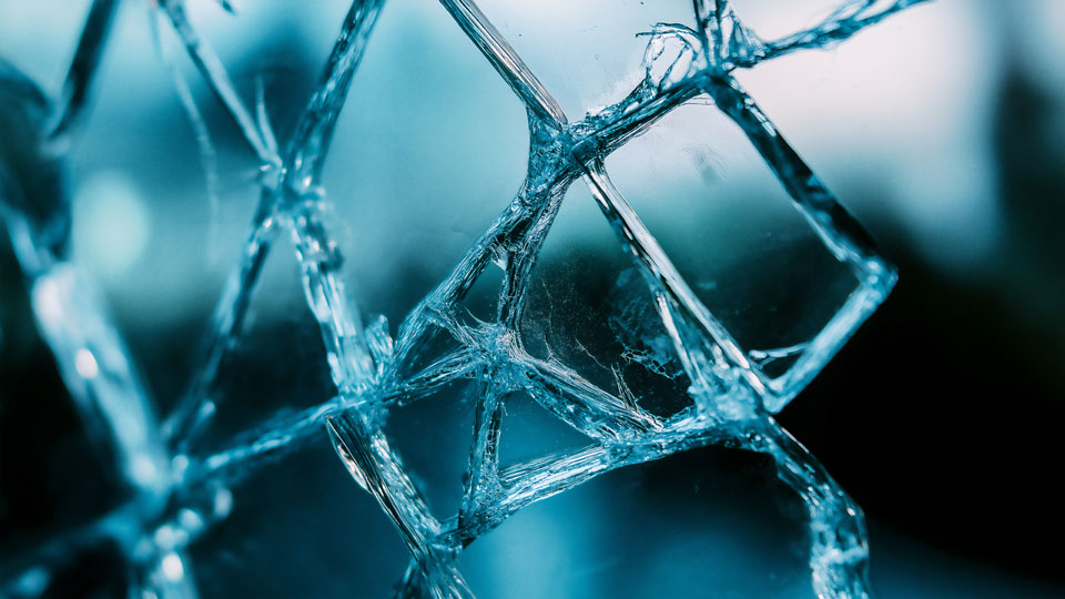 Shattered window detail with blue tones